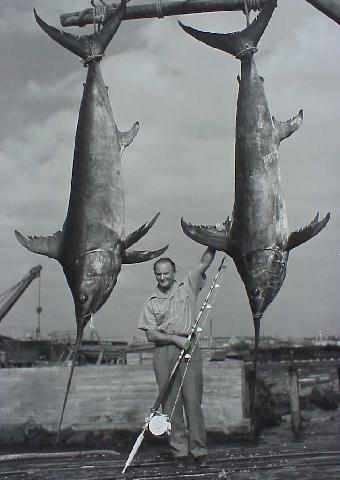 photo of Michael Lerner and two massive swordfish from his 1940 Peru-Chile Expedition